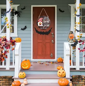 Detail of round wooden door sign with gnome pumpkin print and plaid bow decoration