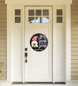 Detail of a round wooden door sign with a gnome illustration and Gnome Sweet Gnome text