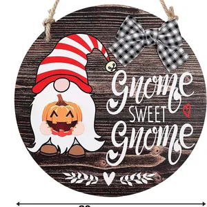 Round wooden door sign featuring a festive gnome with pumpkin and 'Gnome Sweet Gnome' text
