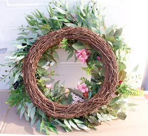 Detail of pink hydrangea and green leaves on a brown vine base for door wall decoration