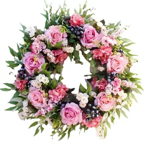 Artificial pink rose wreath with green leaves and berries for home door and wedding decor