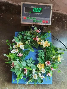 Detail of a 0.22kg colorful floral wreath with pink daisies and green eucalyptus leaves
