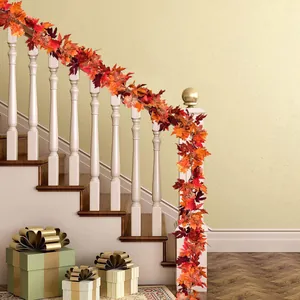 Close-up of vibrant artificial maple leaf garland wrapped on white staircase railing