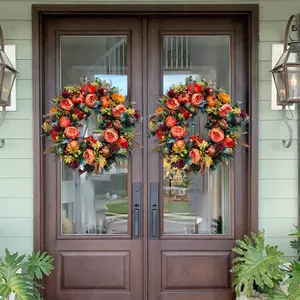 Herbst-Türkranz mit Kürbissen und orangefarbenen Rosen für die Thanksgiving-Deko