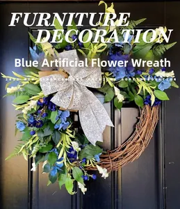 Detail of blue and white artificial flowers on a grapevine wreath with a patterned bow