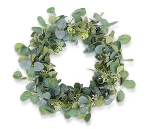 Macro detail of artificial eucalyptus wreath with lush green leaves and small white flowers