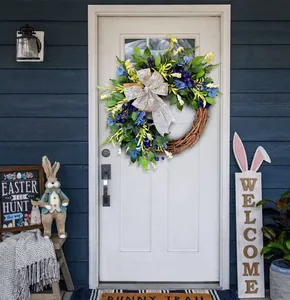 Close-up of Easter spring wreath with blue berries, small flowers, and a sequined bow
