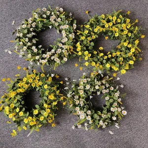 Detailed set of four artificial daisy wreaths in white and yellow for home wall decor