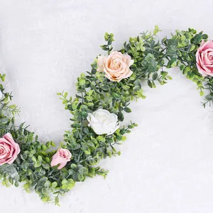 Artificial eucalyptus vine with multi-colored roses for wedding decor on lace
