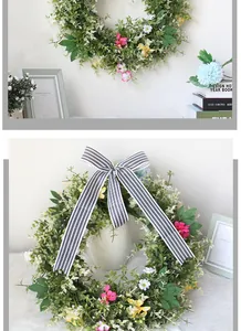 Detail of spring floral wreath with daisies and a black-white striped bow on a wall