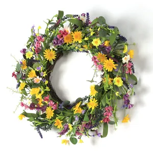 Summer artificial wreath with yellow daisies and purple lavender on a natural rattan base