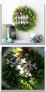 Detail of faux boxwood wreath with a wooden bicycle accent and rustic burlap bow
