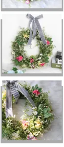 Detail of a floral spring wreath featuring a striped ribbon bow and colorful small daisies