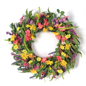 Artificial summer wreath with yellow daisies and lavender on a natural rattan base