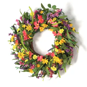 Summer floral wreath with yellow daisies and lavender on a natural rattan base