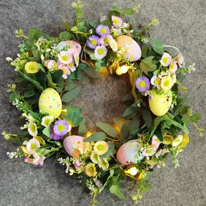 Detail of Easter wreath with colorful eggs, daisies, eucalyptus, and warm LED lights