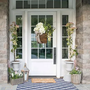 Outdoor hanging willow basket with white hydrangea flowers and a beige polka dot bow