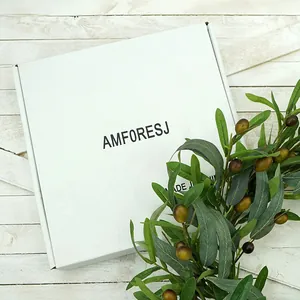 White square packaging box with brand logo on rustic white wood background