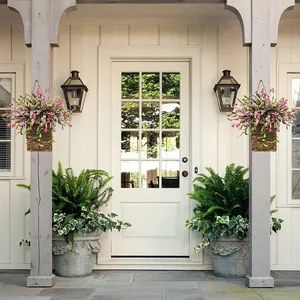 Close-up of artificial pink hydrangea hanging baskets on a white porch for home decor