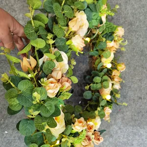 Illuminated Easter wreath with eucalyptus leaves, champagne roses, and warm LED lights