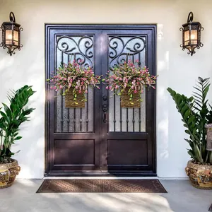 Detail of two pink hydrangea floral hanging baskets on a dark European double door