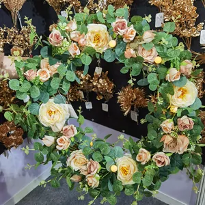 Artificial flower wreath with pink roses, eucalyptus leaves and warm LED fairy lights