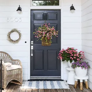 Pink hydrangea artificial flower basket hanging on a dark door for home decoration
