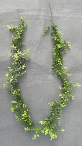 Macro detail of artificial eucalyptus vines with green to yellow gradient plastic leaves