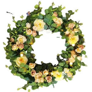 Easter egg wreath with yellow roses, eucalyptus leaves, and LED lights for front door decor
