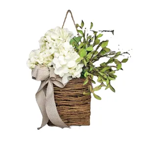 Wall-hanging wicker basket with white hydrangeas and a decorative polka dot ribbon bow