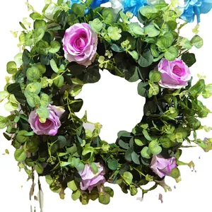 Spring artificial flower wreath with purple roses and eucalyptus leaves for home decor
