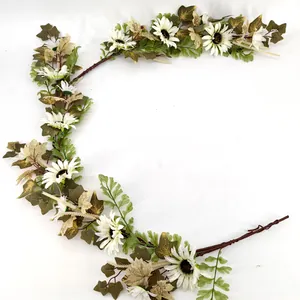 Detailed shot of artificial pumpkin berry and maple vine with white flowers and green ferns