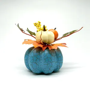 Blue crackle glaze pumpkin centerpiece with maple leaves and berries for autumn decor