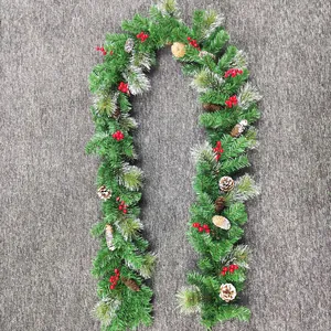 Detail of 2.7m Christmas garland with snow-tipped pine needles, pine cones and red berries