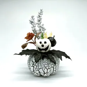 Harvest festival pumpkin ornament with black maple leaves and smiley ghost detail