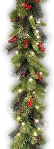 Close-up of 2.7m Christmas garland with pine cones, red berries and warm LED lights