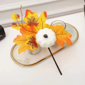 Detail of harvest maple leaves and white pumpkin pick on a white marble tray