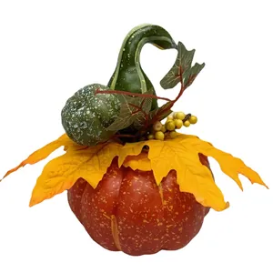 Autumn harvest decoration featuring faux pumpkin, maple leaves and sunflowers for tabletop