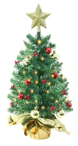 Close-up of a 24-inch mini Christmas tree with gold star, red berries, and warm LED lights