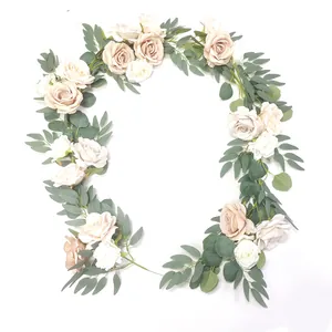 Close-up of champagne and cream artificial roses with eucalyptus leaves for wedding decor