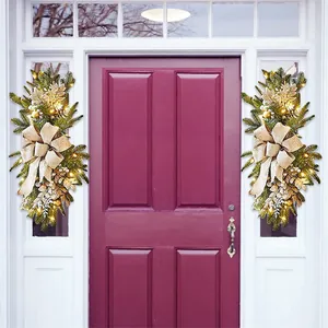 Christmas staircase swags with gold bows and LED lights on a white door frame