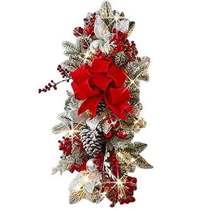 Christmas staircase swag with red velvet bow, silver pine cones and LED berries