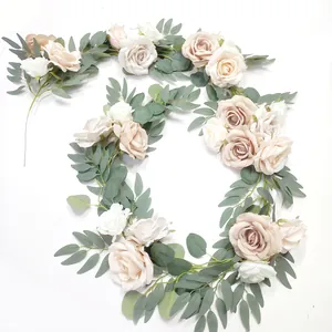 Close-up of artificial rose garland with champagne silk flowers and eucalyptus leaves