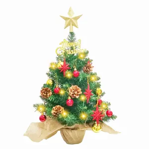 Mini artificial tabletop Christmas tree with gold star, ornaments, and warm LED lights