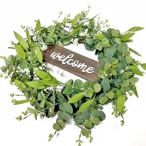 Eucalyptus wreath with white berries and wooden welcome sign for home garden decor