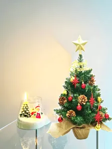 Close-up of a 24-inch mini artificial Christmas tree with red gold ornaments and burlap base