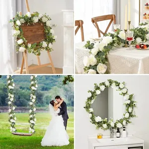 Detailed close-up of white roses and eucalyptus vine for wedding and home decor
