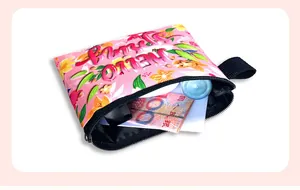 Detail of pink plush floral pouch showing interior storage for cards and cash