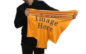 Detail of stretchable orange luggage cover showing high-elasticity fabric and zipper base