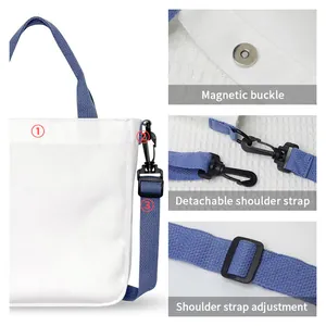 White canvas crossbody bag with blue adjustable strap and secure magnetic buckle closure